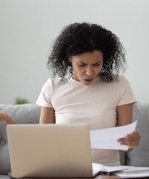 Angry stressed african girl reading bad news in mail letter