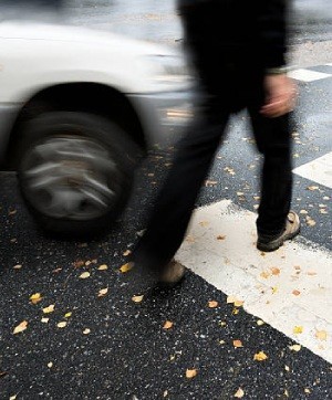 Pedestrian crossing in danger of being hit